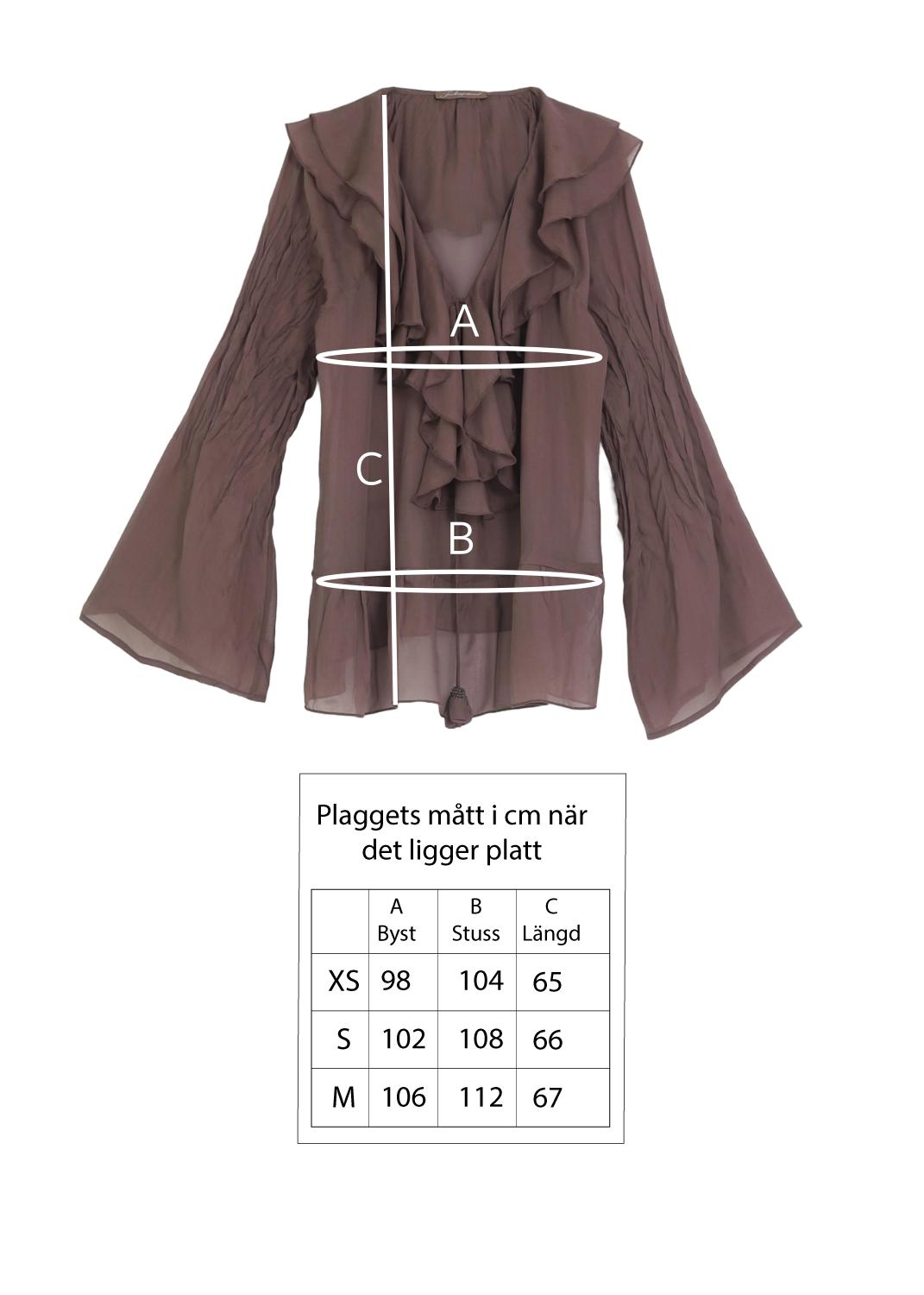 Blus med volanger i siden