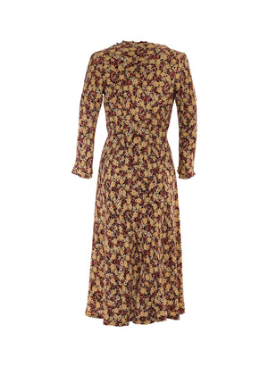 Solros blommig Crepe viskos klänning, hög midja, extra vidd i kjolen. V-ringad med  klockformade ärmar ger en 70s bohemisk look. 